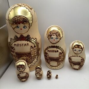 Bosnian nesting dolls , wood and gold